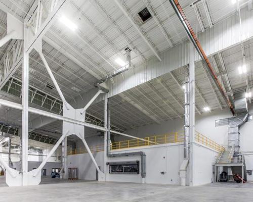 Interior of Lufthansa Technik Heavy Maintenance Facility. Large open space with white walls and bright lighting.